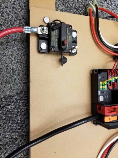 Highlights the location of the terminal lugs on the PDH and circuit breaker.